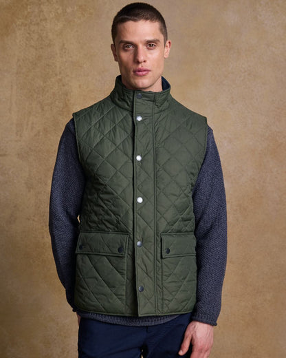 Olive Coloured Jack Murphy Mens Conor Quilted Gilet on indoor background 