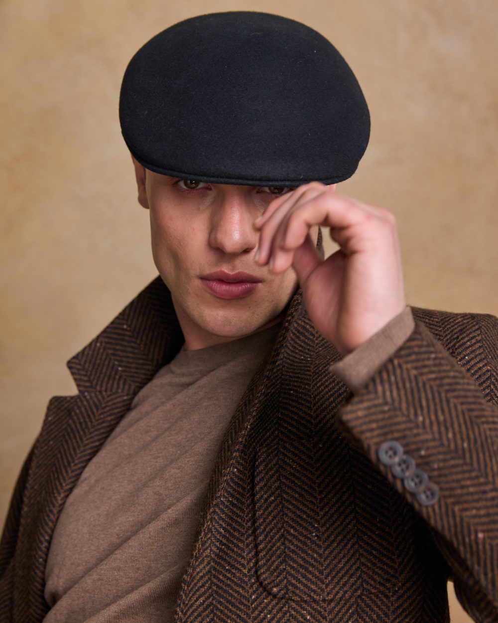 Black Coloured Jack Murphy Mens Galway Felt Flat Cap on indoor background 