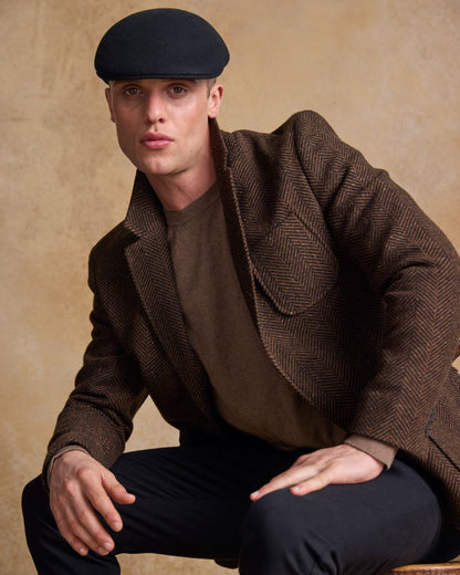 Black Coloured Jack Murphy Mens Galway Felt Flat Cap on indoor background 