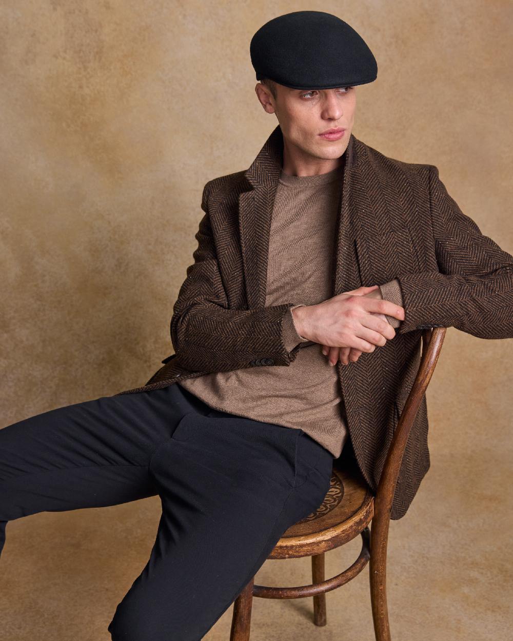 Black Coloured Jack Murphy Mens Galway Felt Flat Cap on indoor background 