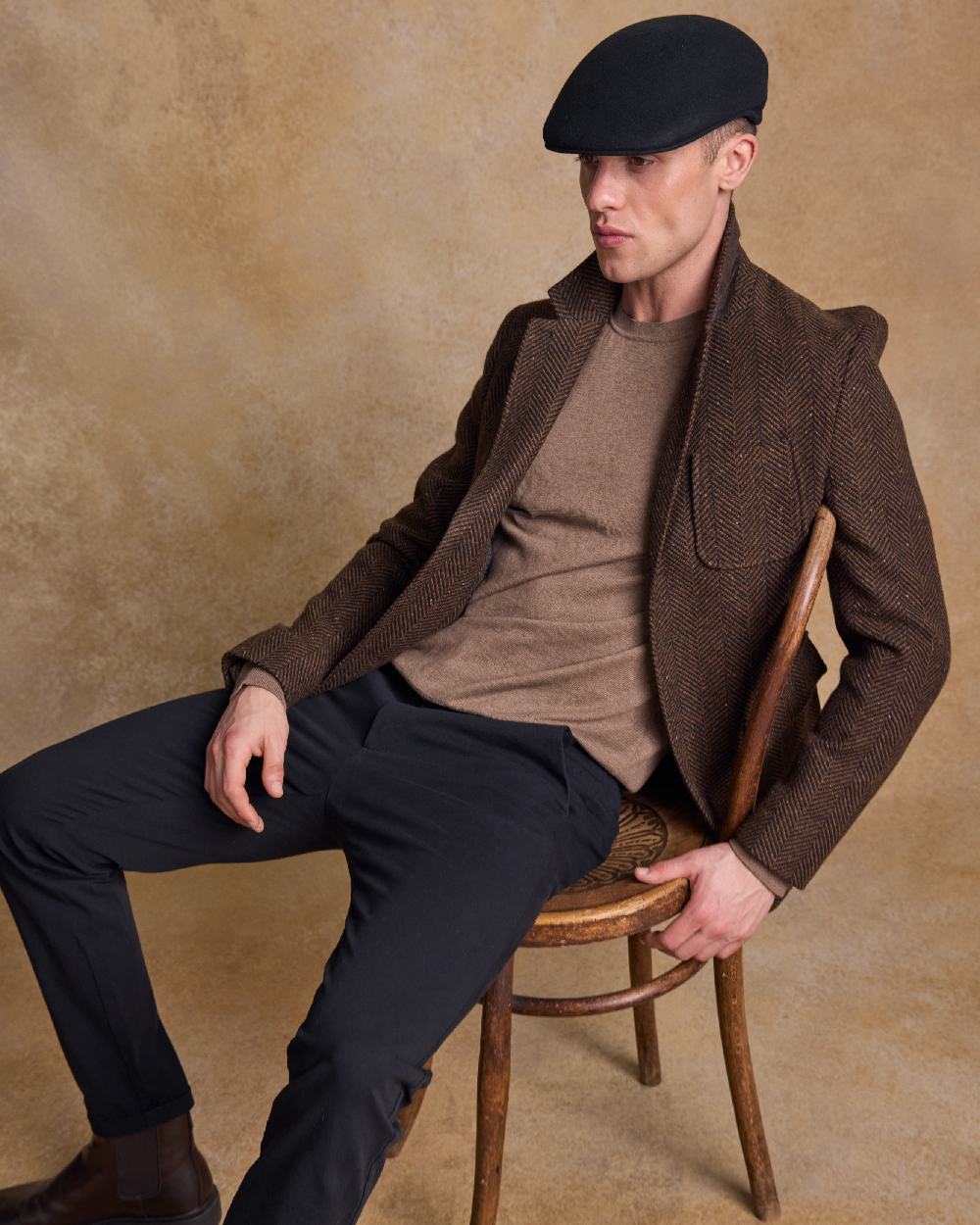 Black Coloured Jack Murphy Mens Galway Felt Flat Cap on indoor background 