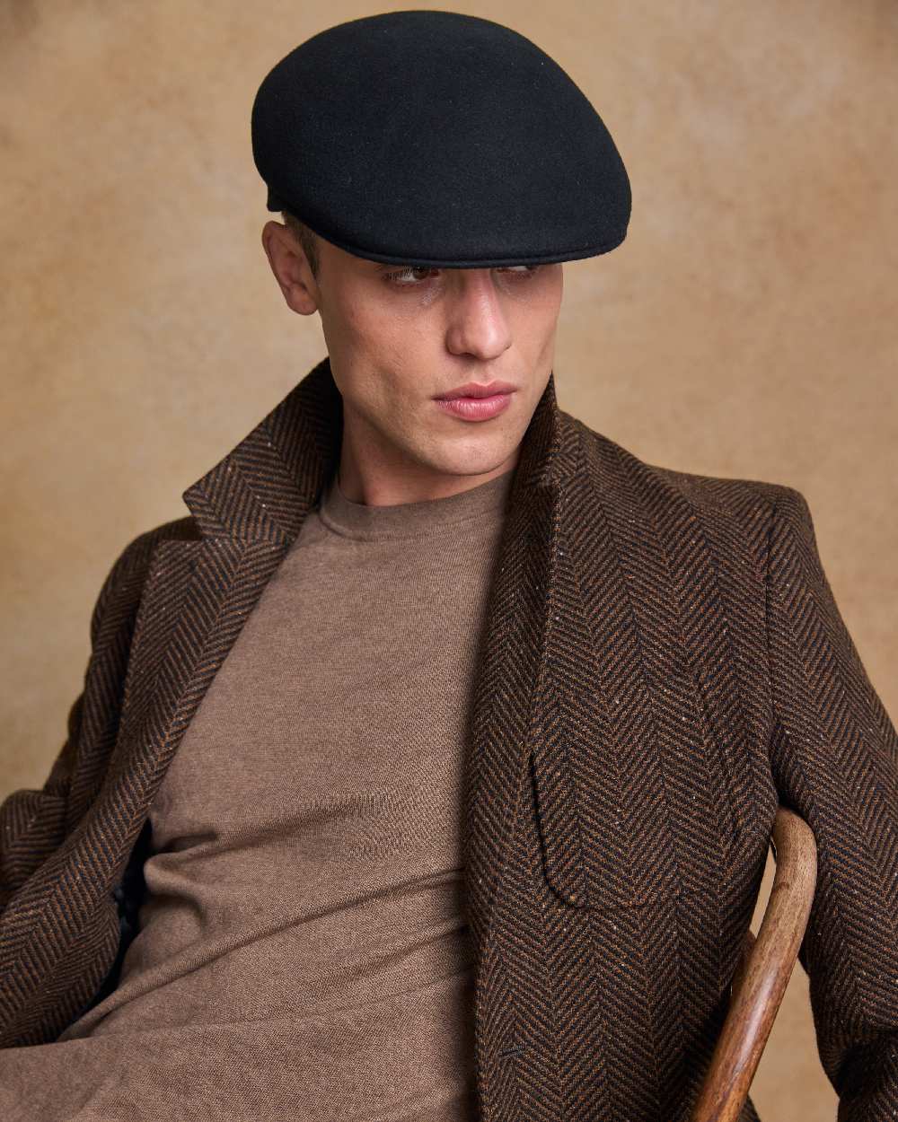 Black Coloured Jack Murphy Mens Galway Felt Flat Cap on indoor background 