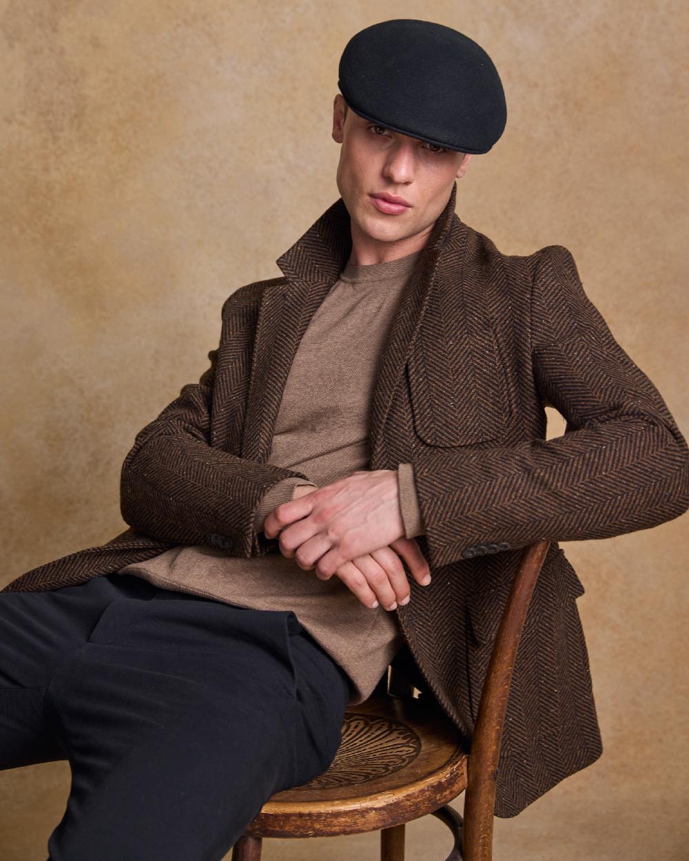 Black Coloured Jack Murphy Mens Galway Felt Flat Cap on indoor background 