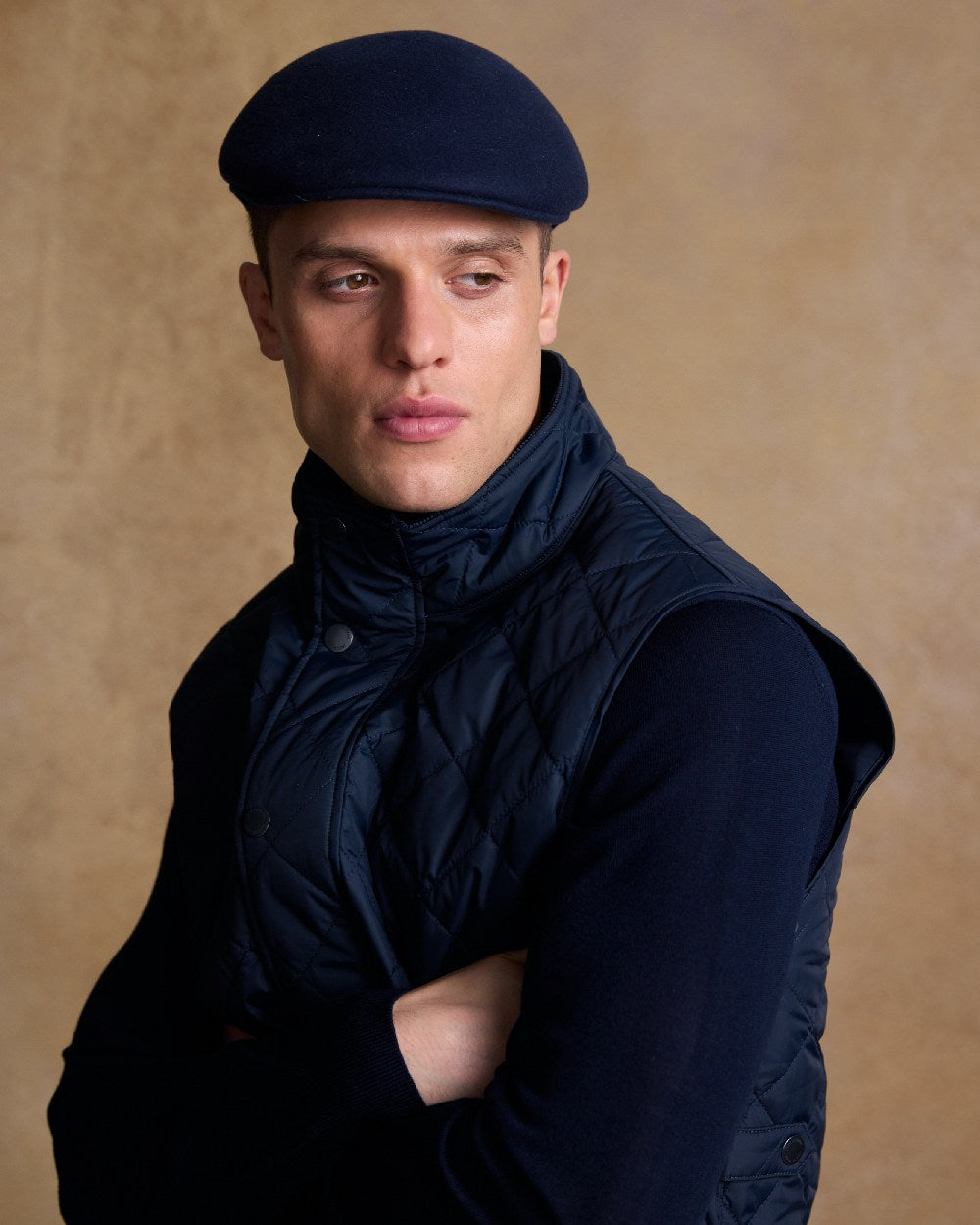 True Navy Coloured Jack Murphy Mens Galway Felt Flat Cap on indoor background 
