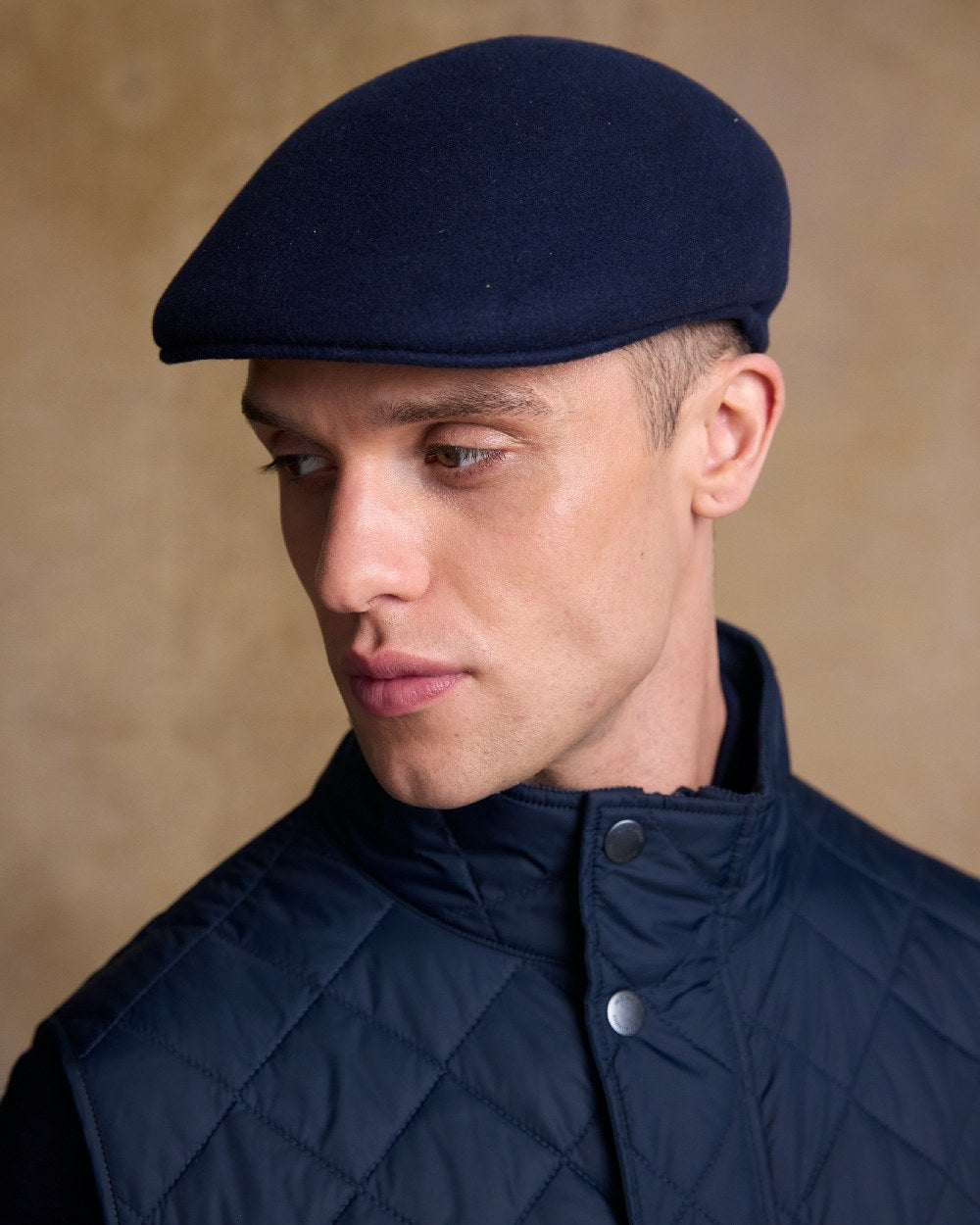 True Navy Coloured Jack Murphy Mens Galway Felt Flat Cap on indoor background 