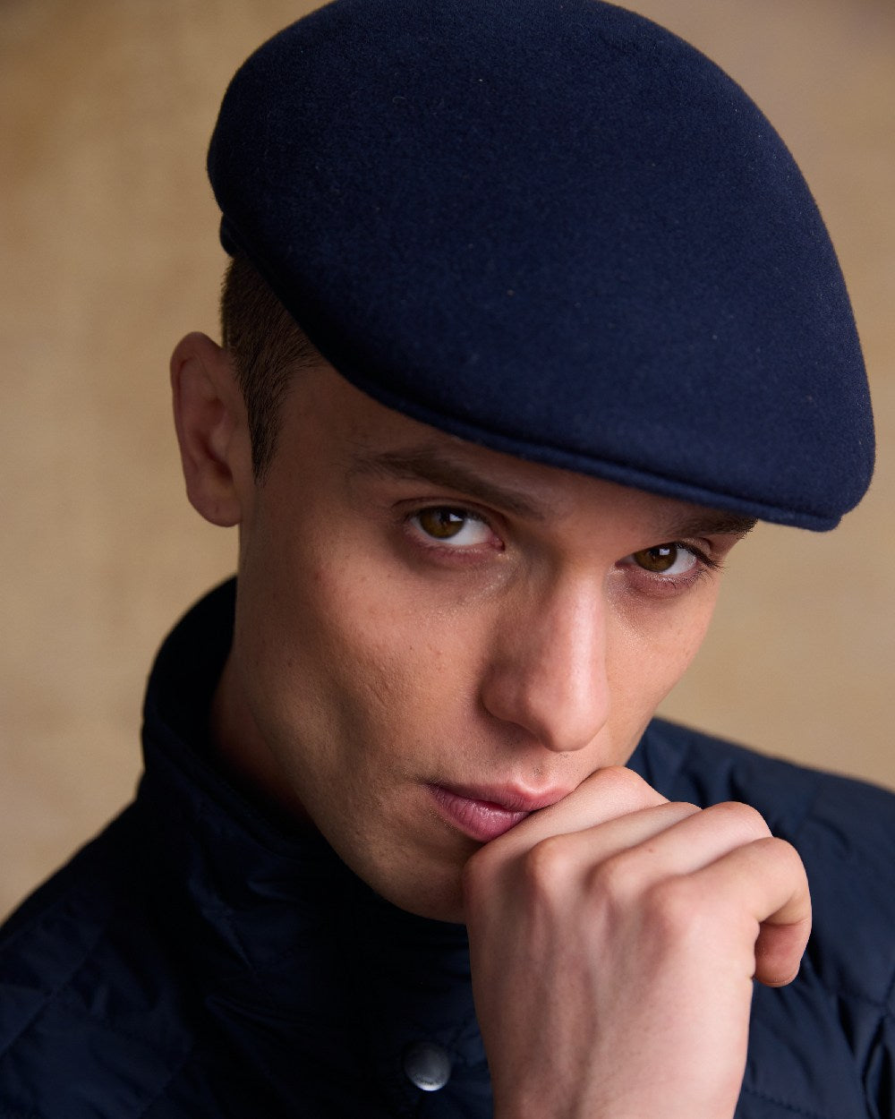 True Navy Coloured Jack Murphy Mens Galway Felt Flat Cap on indoor background 