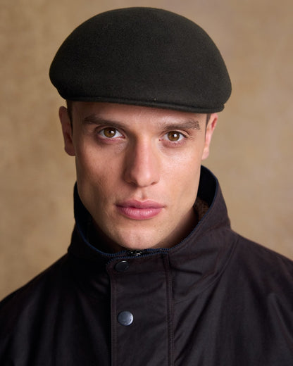 Olive Coloured Jack Murphy Mens Galway Felt Flat Cap on indoor background 