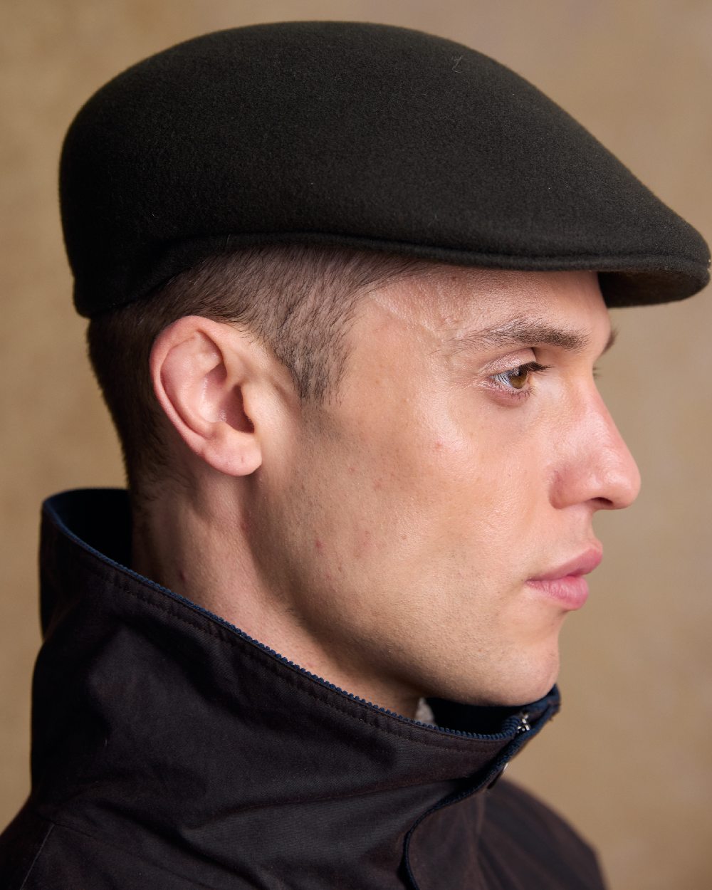 Olive Coloured Jack Murphy Mens Galway Felt Flat Cap on indoor background 