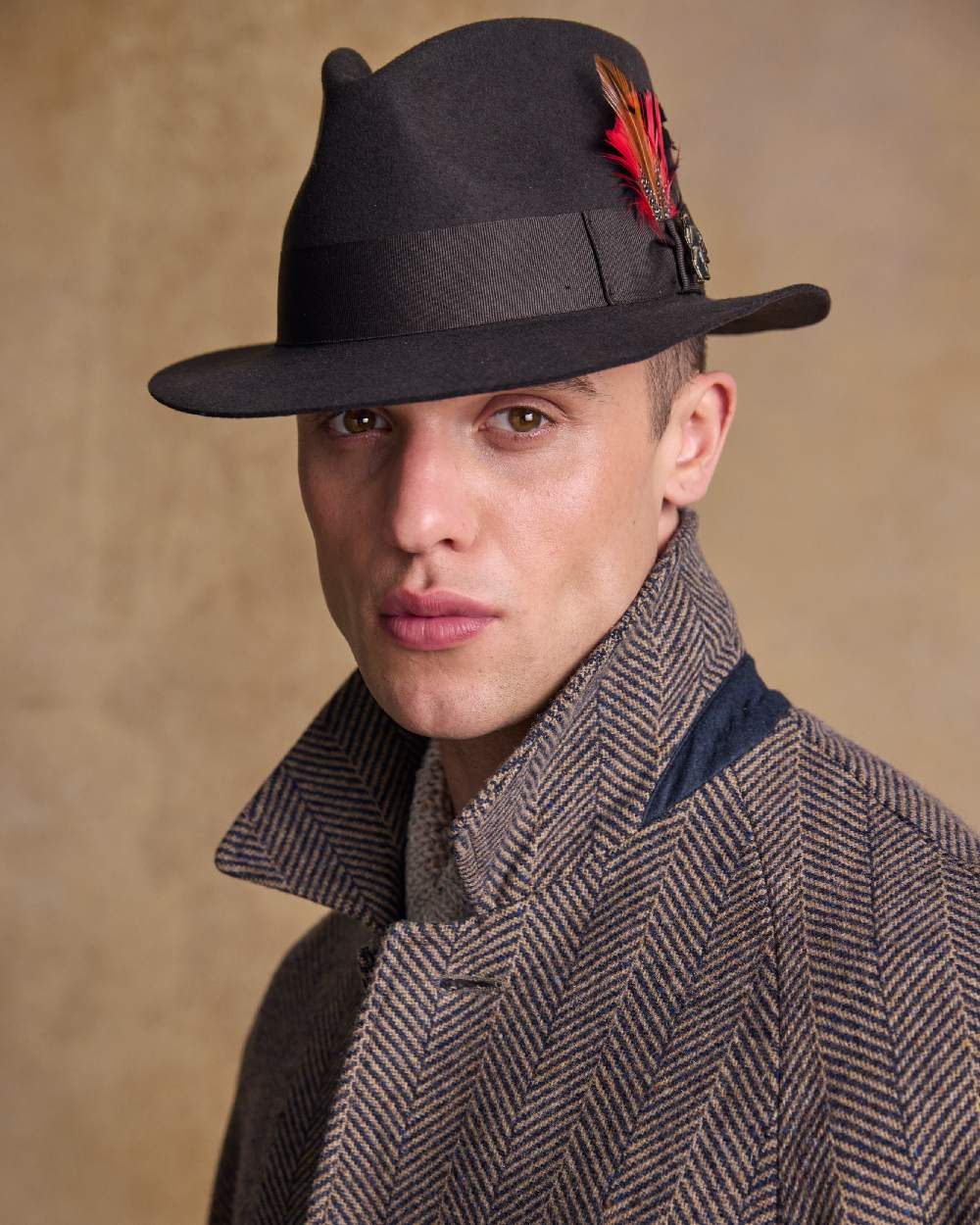 Brown Coloured Jack Murphy Mens Kildare Trilby Felt Hat on indoor background 