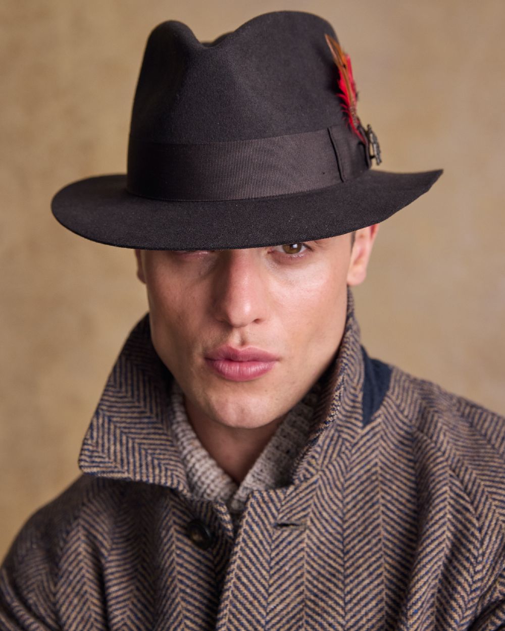 Brown Coloured Jack Murphy Mens Kildare Trilby Felt Hat on indoor background 