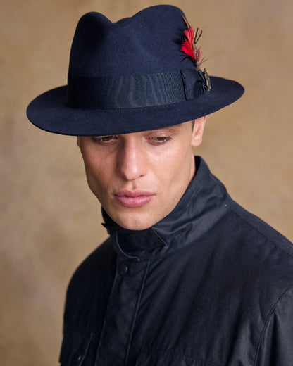 Navy Coloured Jack Murphy Mens Kildare Trilby Felt Hat on indoor background 