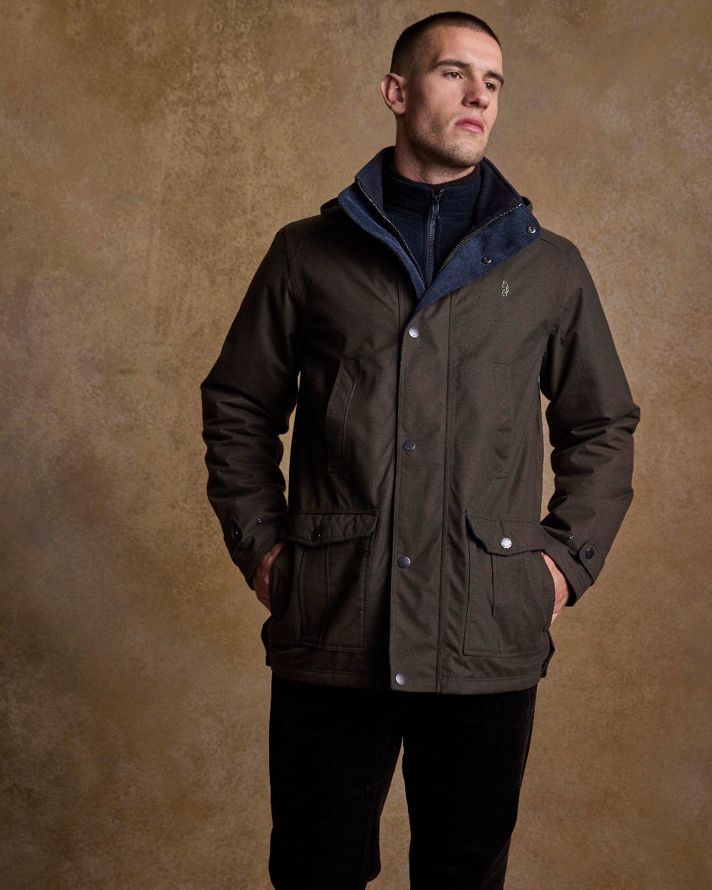 Olive Coloured Jack Murphy Mens Michael Waterproof Jacket on indoor background 