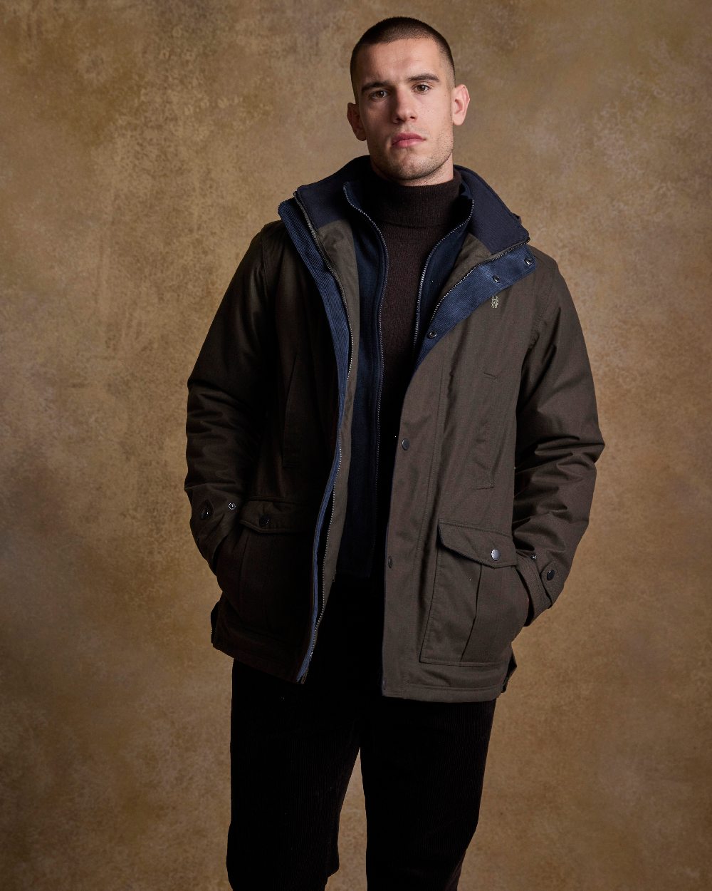 Olive Coloured Jack Murphy Mens Michael Waterproof Jacket on indoor background 