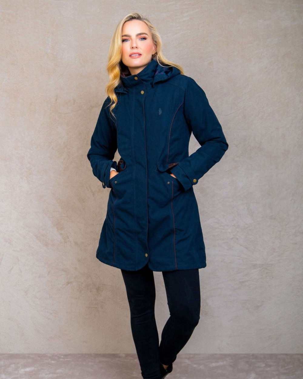 Heritage Navy coloured Jack Murphy Una 3/4 Waterproof Coat on wall background 