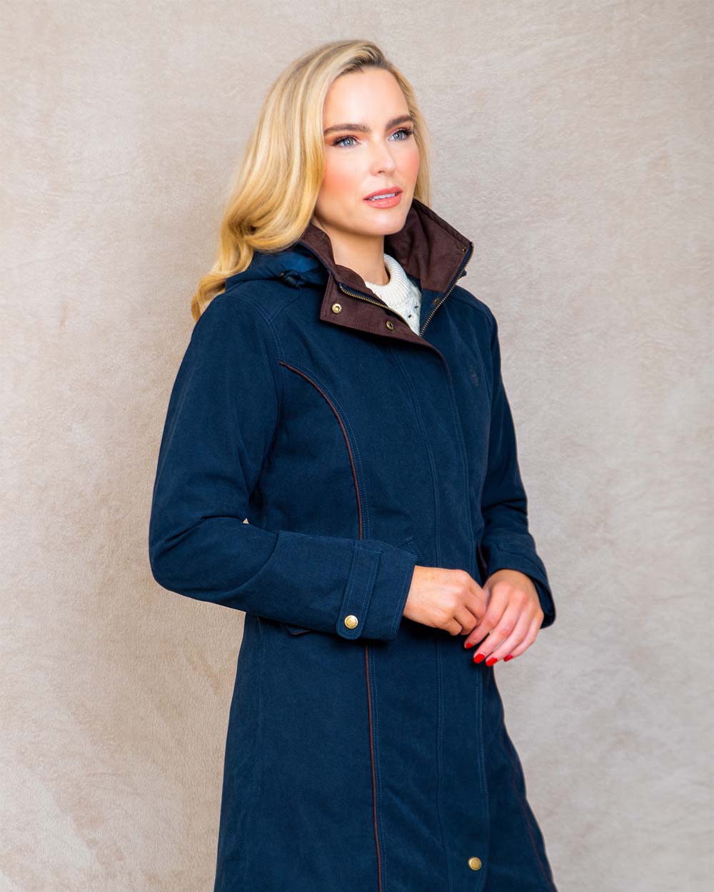 Heritage Navy coloured Jack Murphy Una 3/4 Waterproof Coat on wall background 