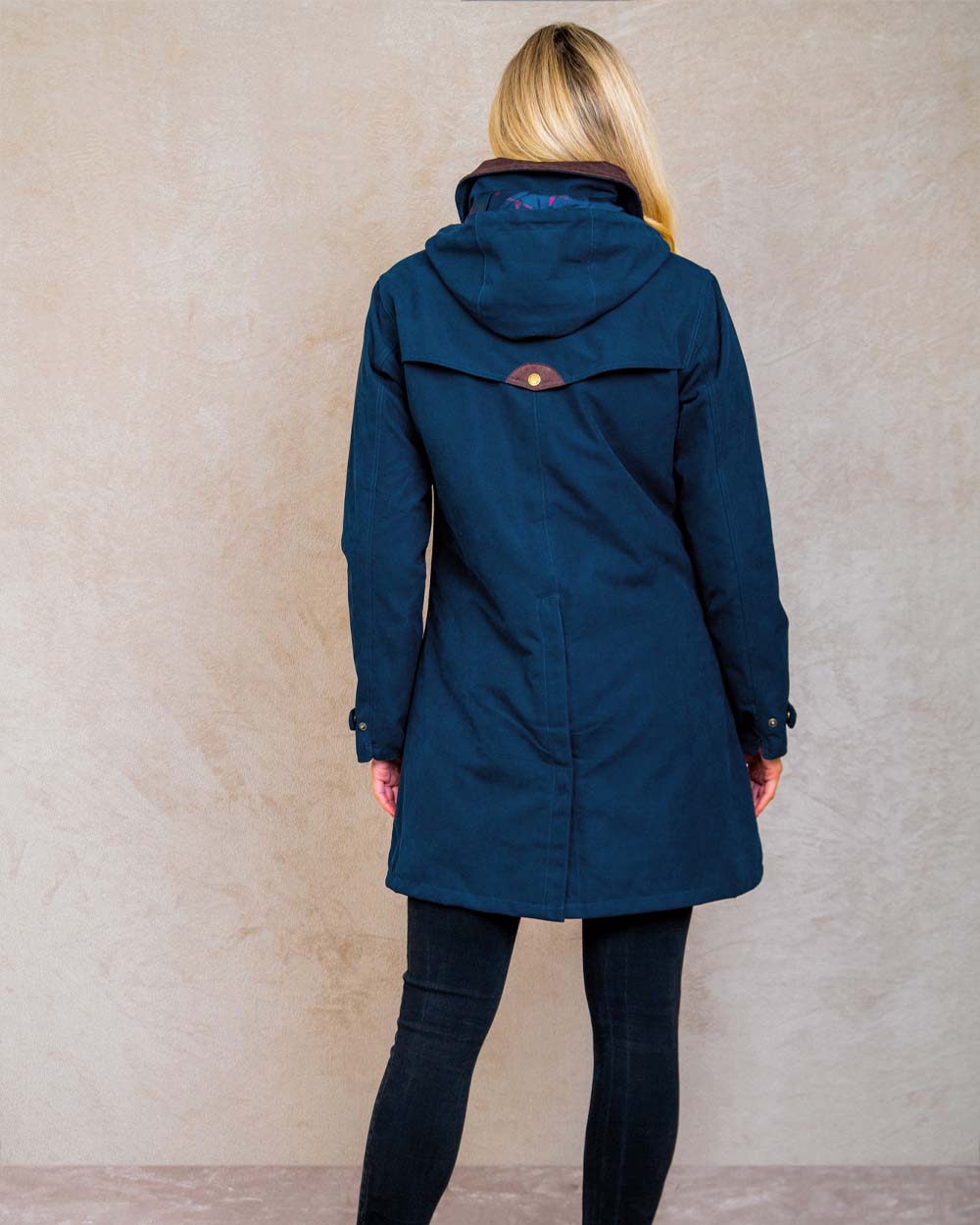 Heritage Navy coloured Jack Murphy Una 3/4 Waterproof Coat on wall background 