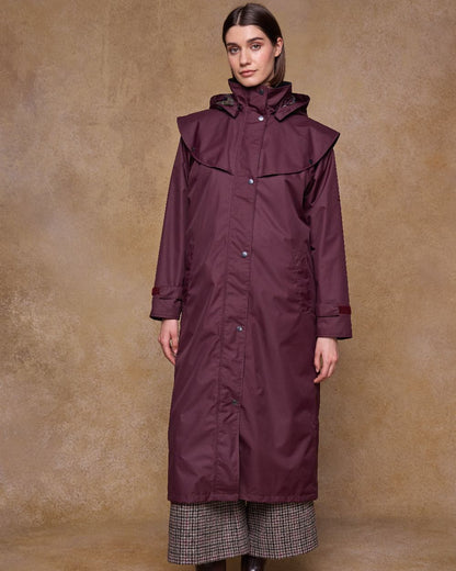 Deep Claret Coloured Jack Murphy Womens Connemara Waterproof Coat on indoor background 