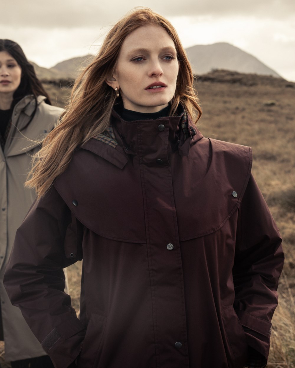 Deep Claret Coloured Jack Murphy Womens Connemara Waterproof Coat on mountain background 