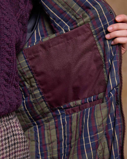 Deep Claret Coloured Jack Murphy Womens Connemara Waterproof Coat on indoor background 