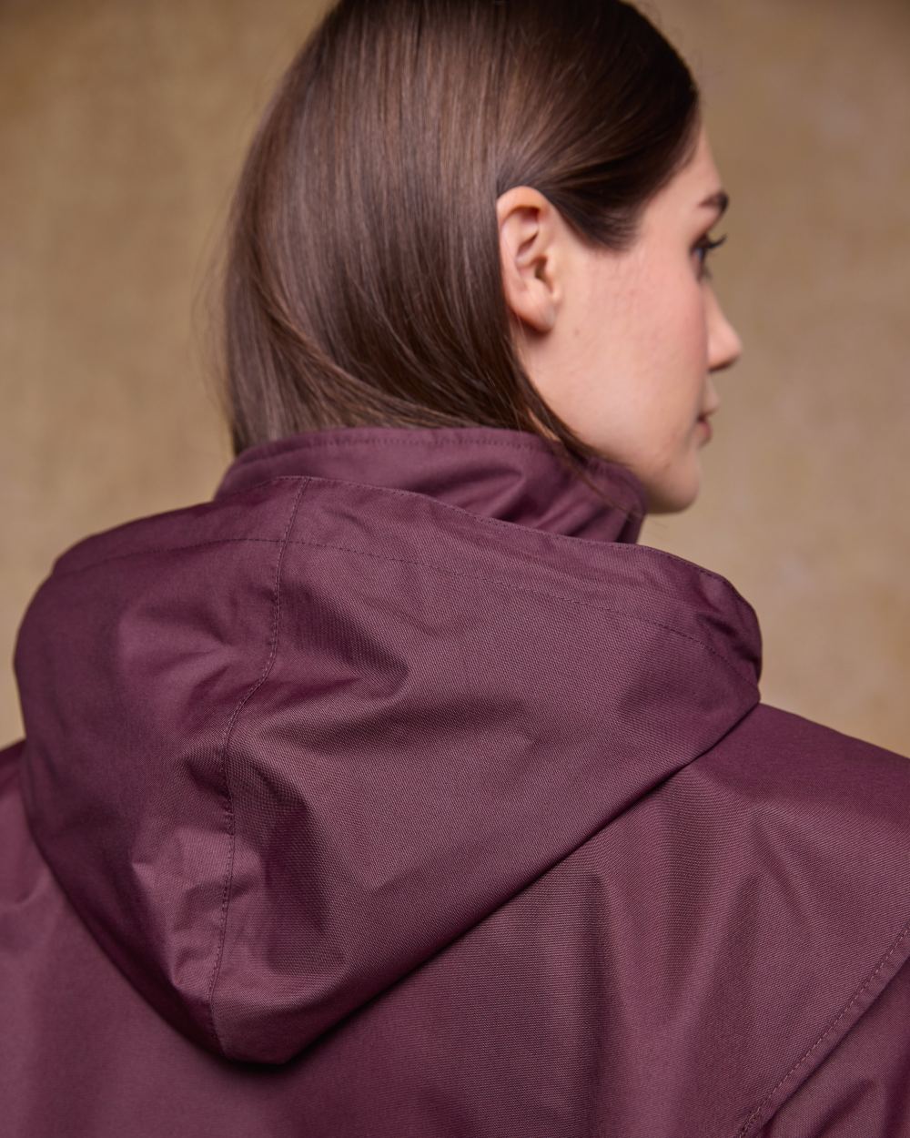 Deep Claret Coloured Jack Murphy Womens Connemara Waterproof Coat on indoor background 