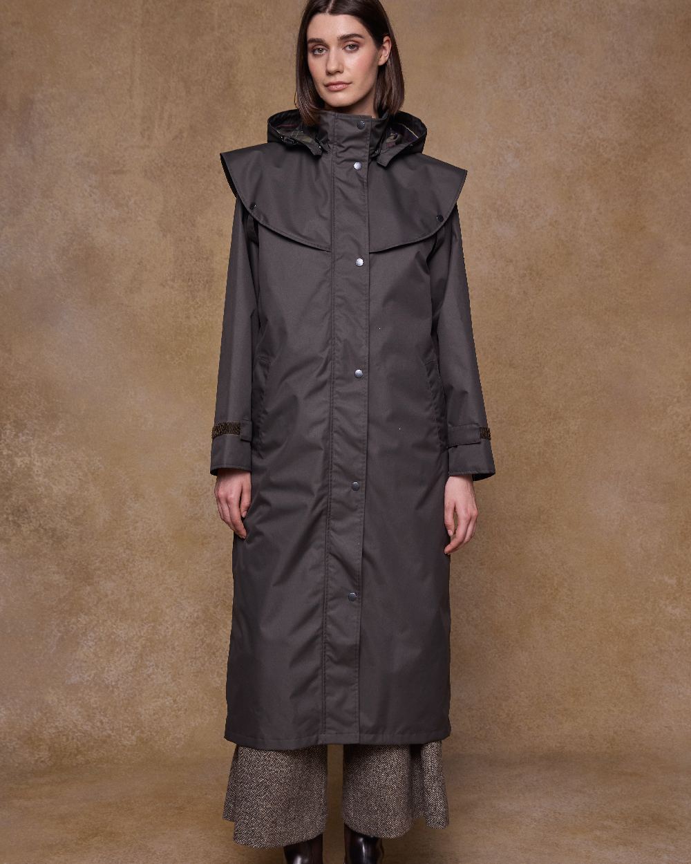 Olive Coloured Jack Murphy Womens Connemara Waterproof Coat on indoor background 