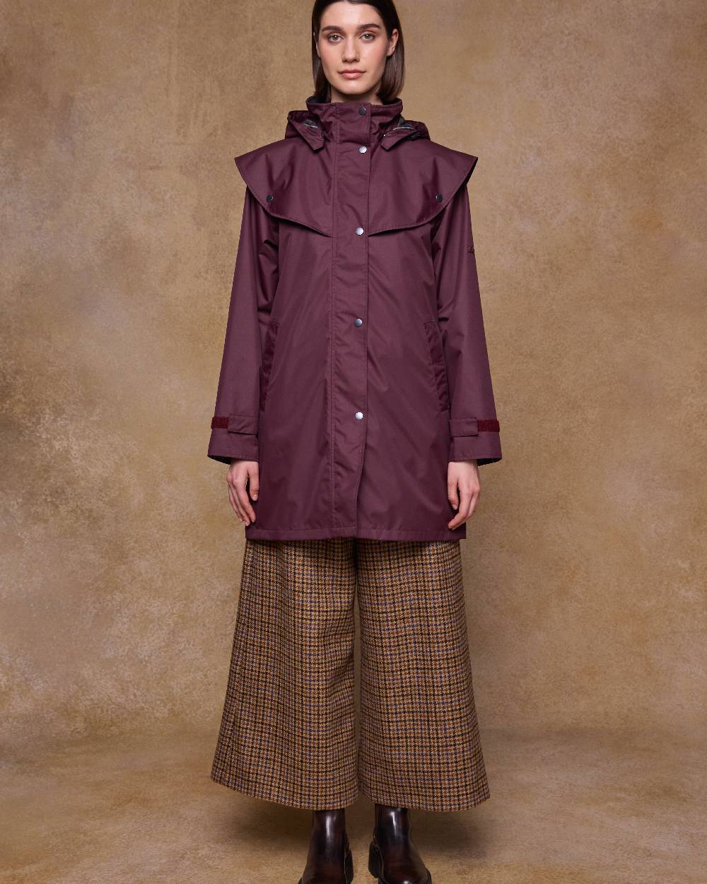 Deep Claret Coloured Jack Murphy Womens Dingle Waterproof Jacket on indoor background 