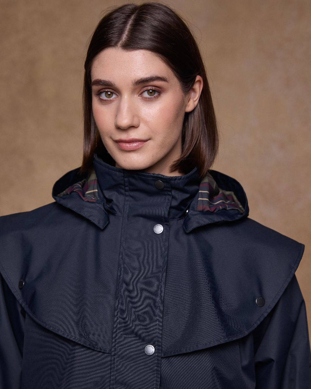 Navy Coloured Jack Murphy Womens Dingle Waterproof Jacket on indoor background 