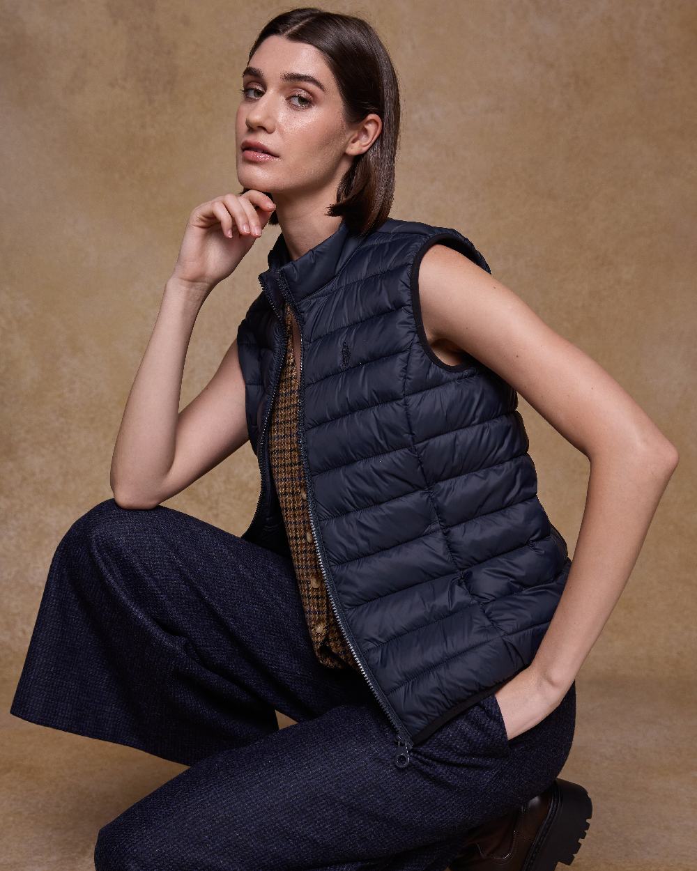 Navy Coloured Jack Murphy Womens Leah Puffa Gilet on indoor background 