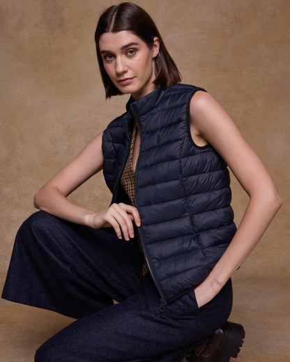 Navy Coloured Jack Murphy Womens Leah Puffa Gilet on indoor background 