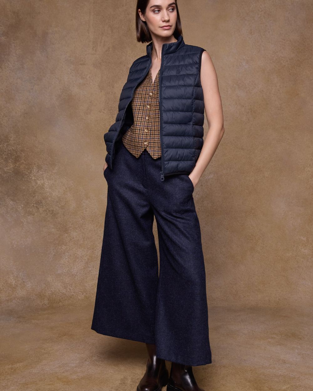 Navy Coloured Jack Murphy Womens Leah Puffa Gilet on indoor background 
