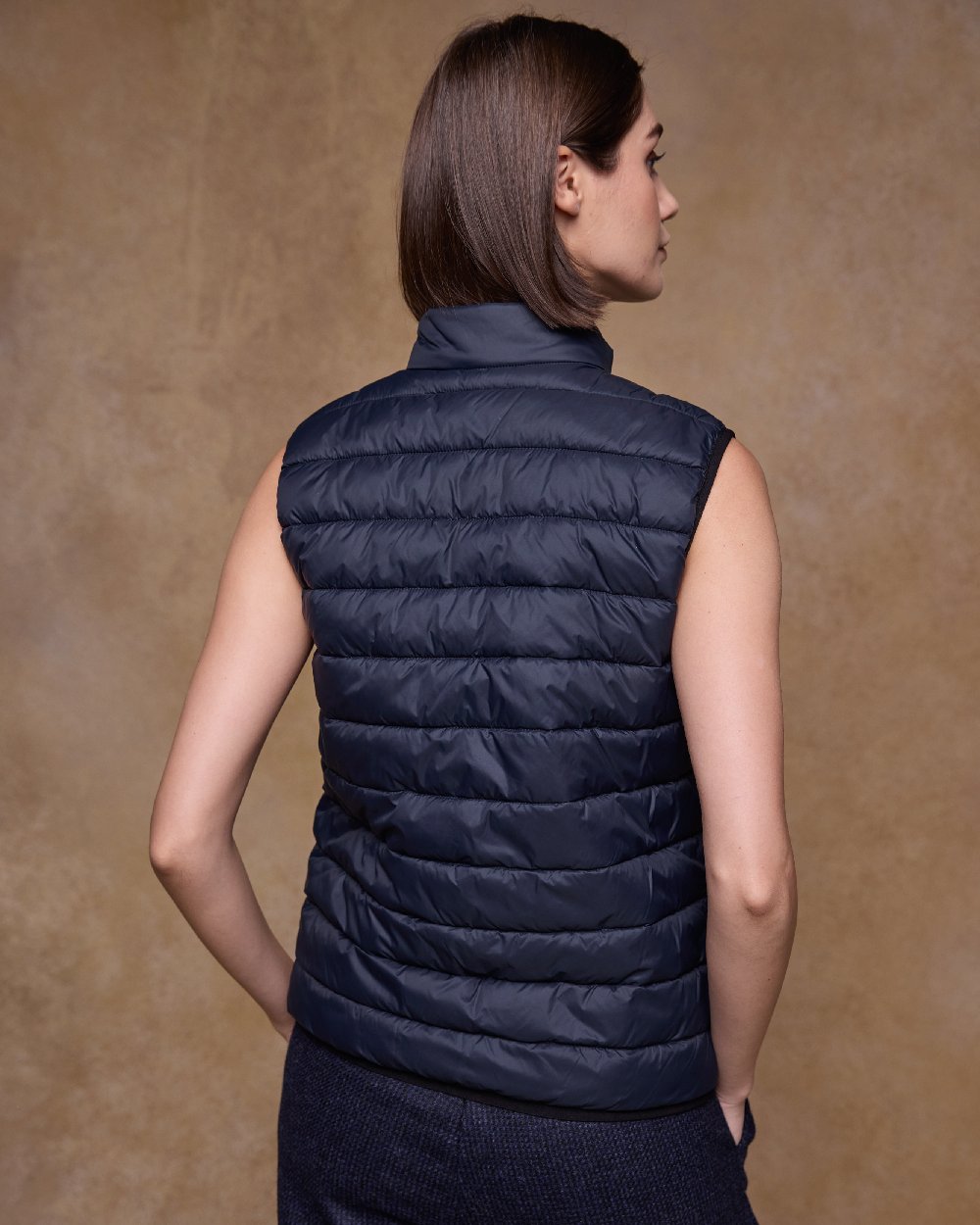 Navy Coloured Jack Murphy Womens Leah Puffa Gilet on indoor background 