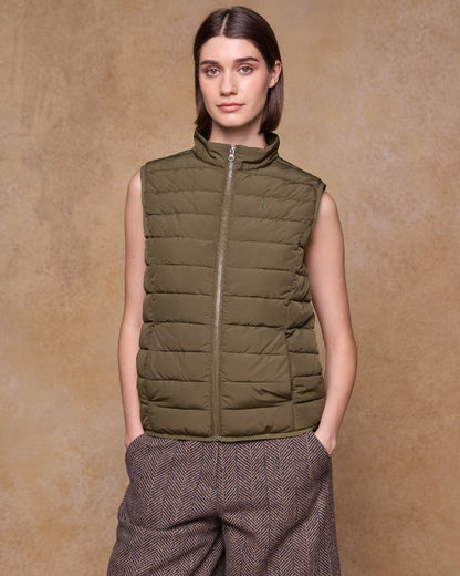 Olive Coloured Jack Murphy Womens Leah Puffa Gilet on indoor background 