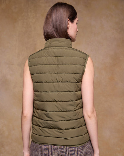 Olive Coloured Jack Murphy Womens Leah Puffa Gilet on indoor background 