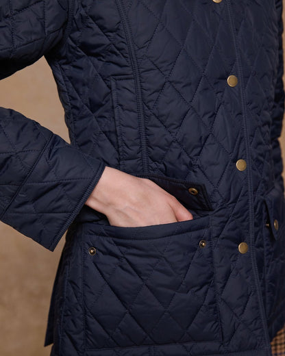Navy coloured Jack Murphy Womens Molly Quilted Jacket on wall background 
