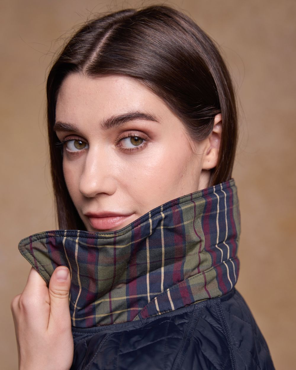 Navy coloured Jack Murphy Womens Molly Quilted Jacket on wall background 