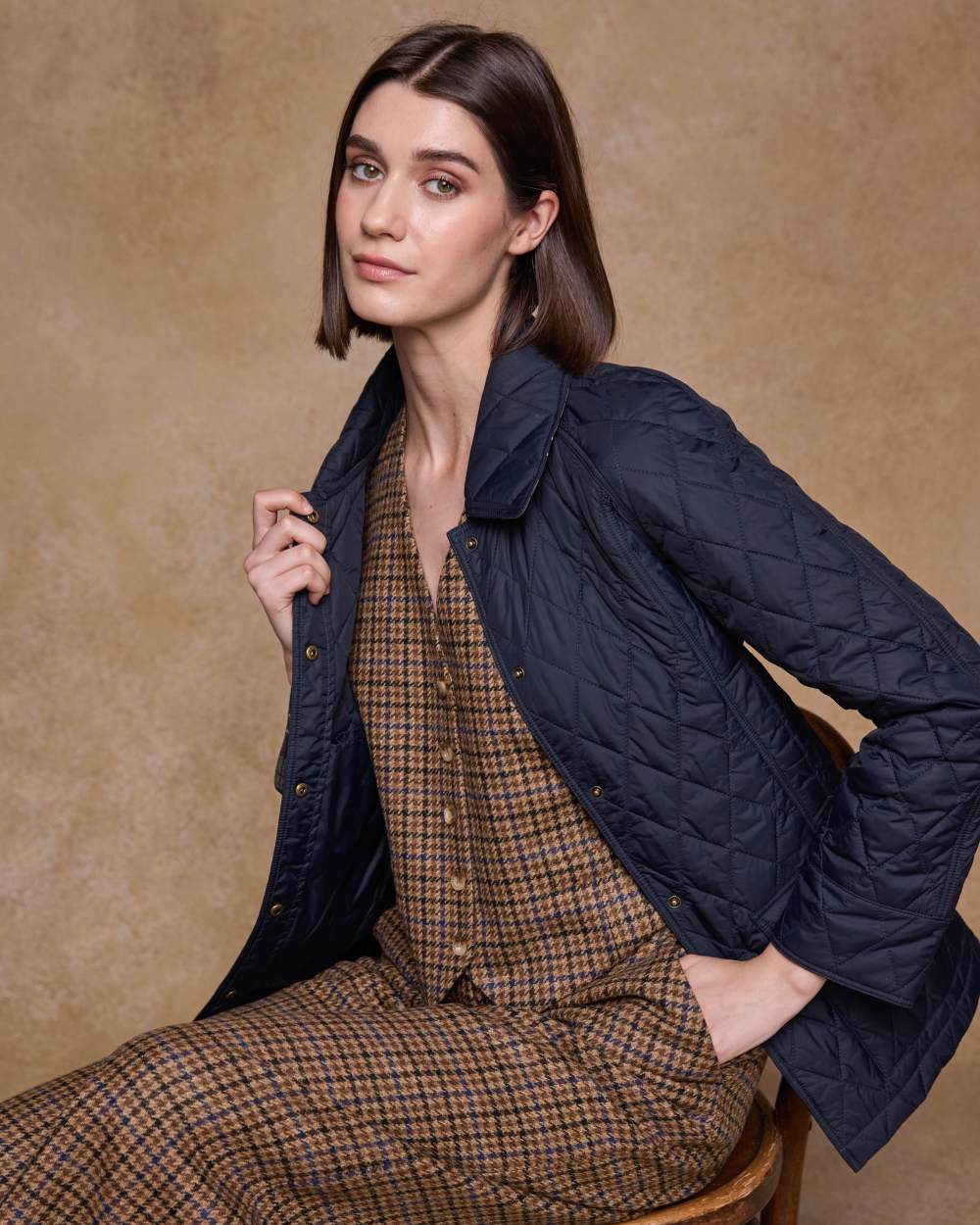 Navy coloured Jack Murphy Womens Molly Quilted Jacket on wall background 
