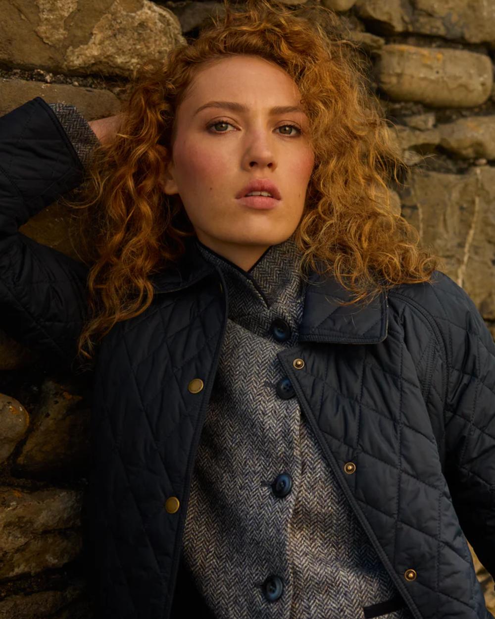 Navy coloured Jack Murphy Womens Molly Quilted Jacket on rock background 