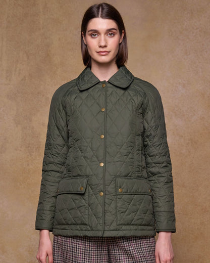 Olive coloured Jack Murphy Womens Molly Quilted Jacket on wall background 