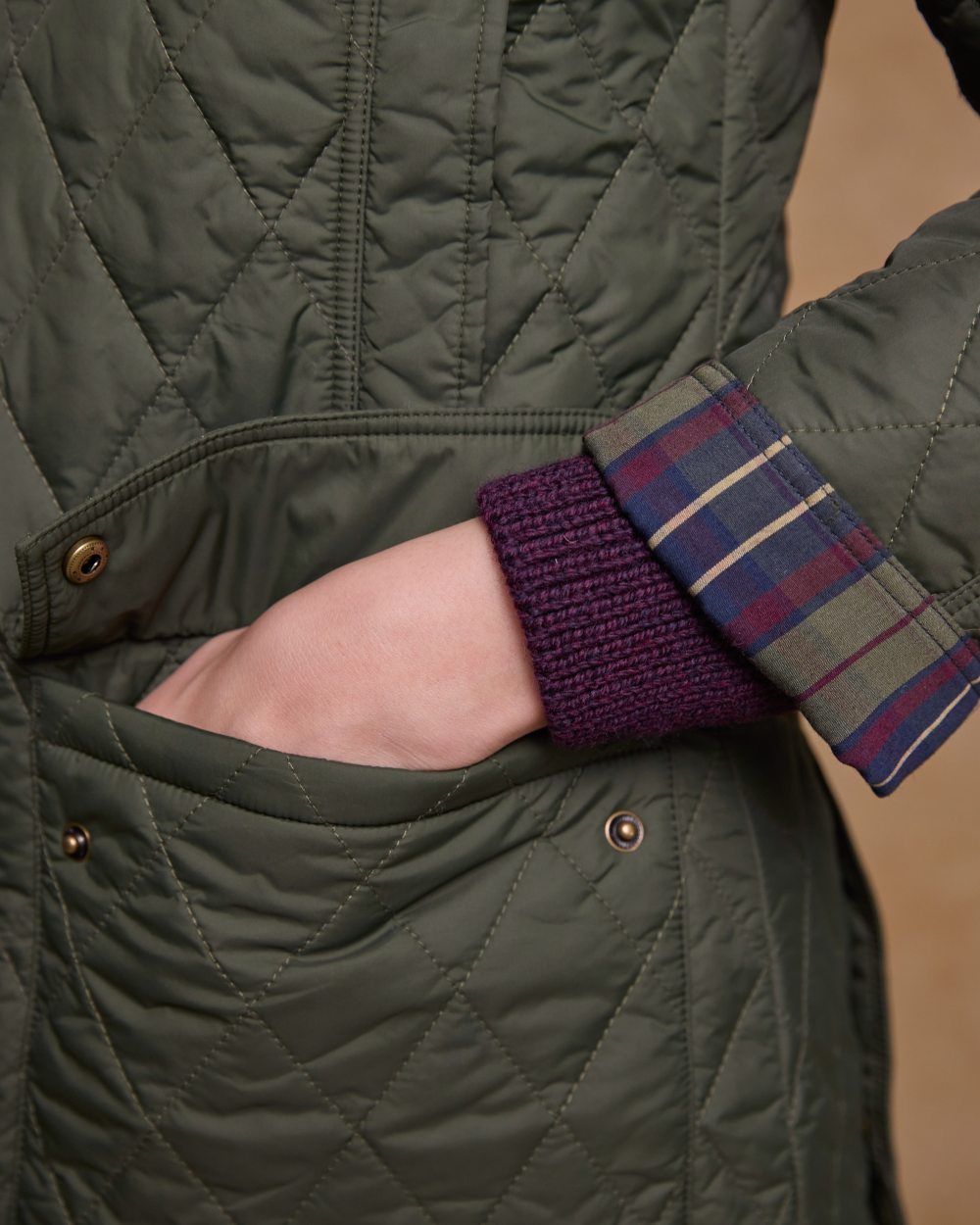 Olive coloured Jack Murphy Womens Molly Quilted Jacket on wall background 