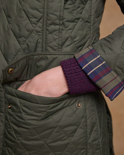 Olive coloured Jack Murphy Womens Molly Quilted Jacket on wall background 