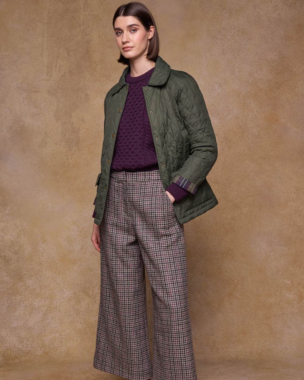Olive coloured Jack Murphy Womens Molly Quilted Jacket on wall background 