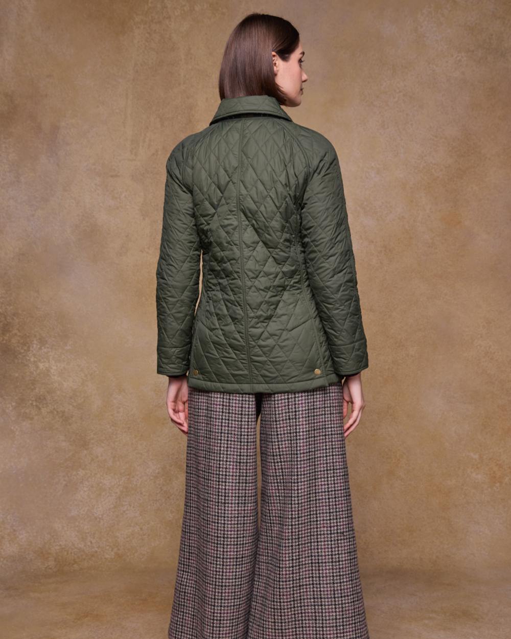 Olive coloured Jack Murphy Womens Molly Quilted Jacket on wall background 