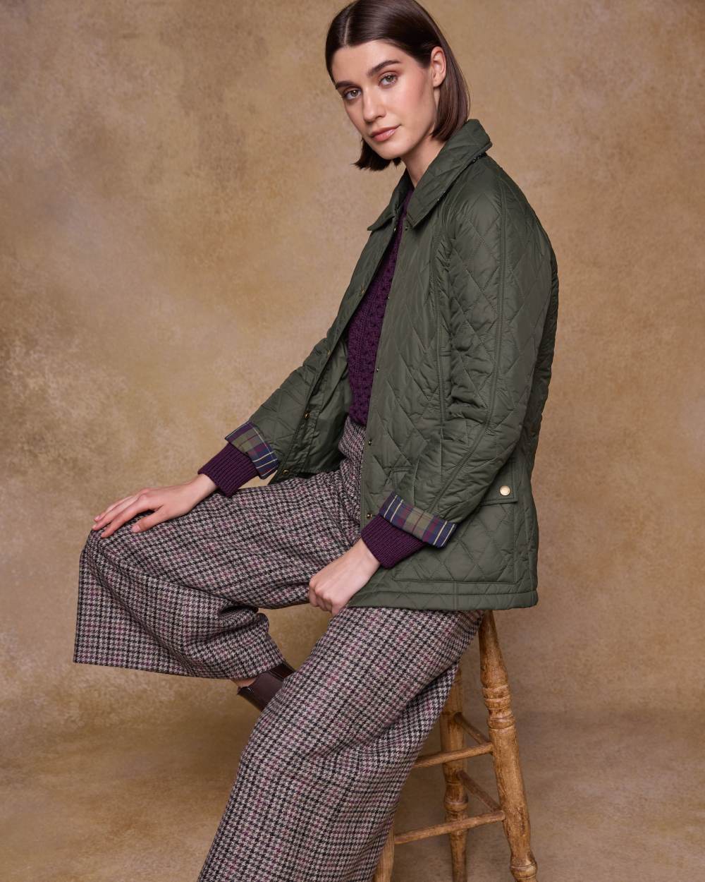 Olive coloured Jack Murphy Womens Molly Quilted Jacket on wall background 
