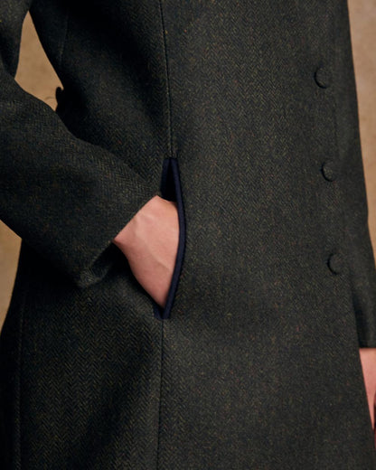 Deep Green Herringbone coloured Jack Murphy Womens Robin Tweed Coat on textured background 