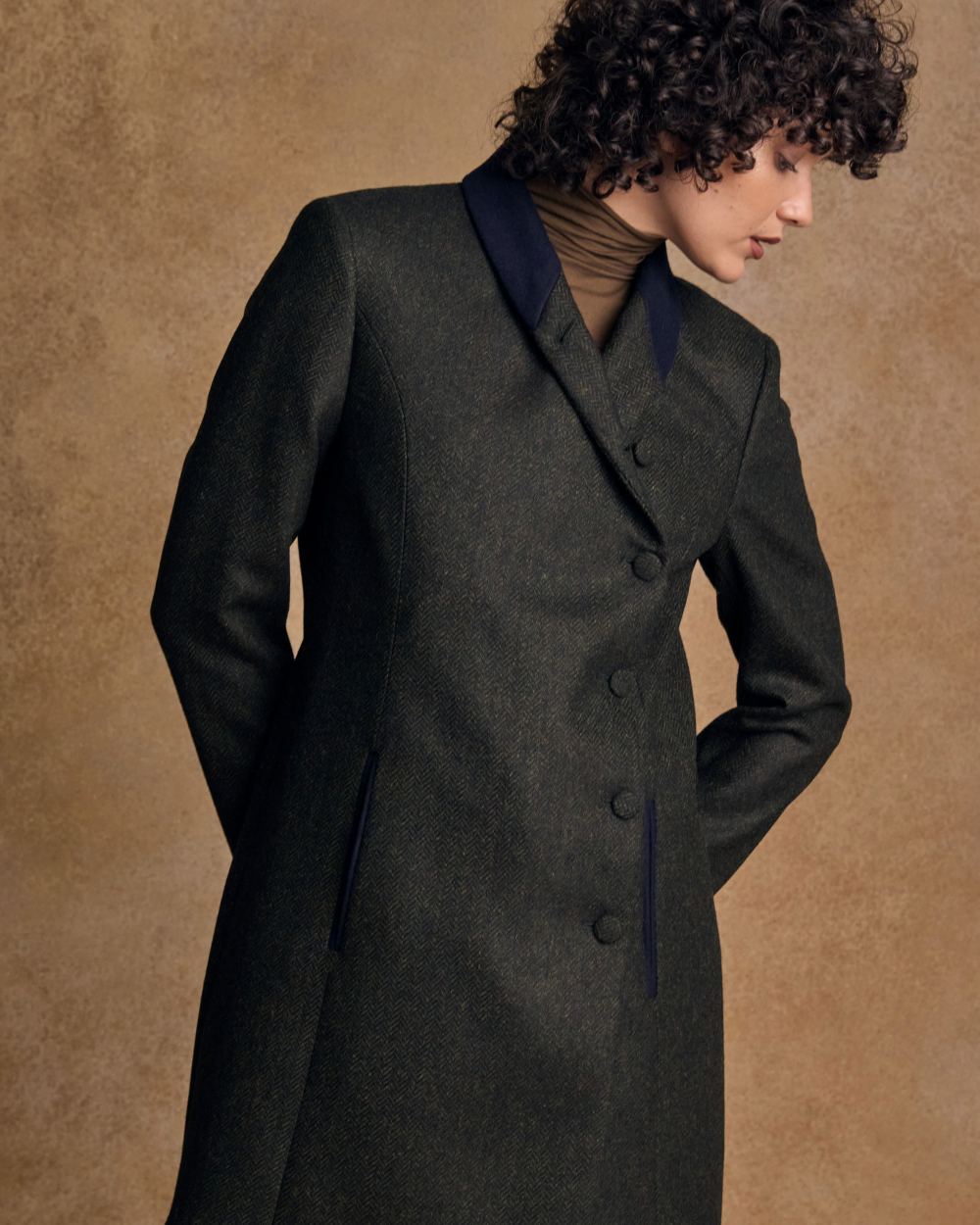Deep Green Herringbone coloured Jack Murphy Womens Robin Tweed Coat on textured background 