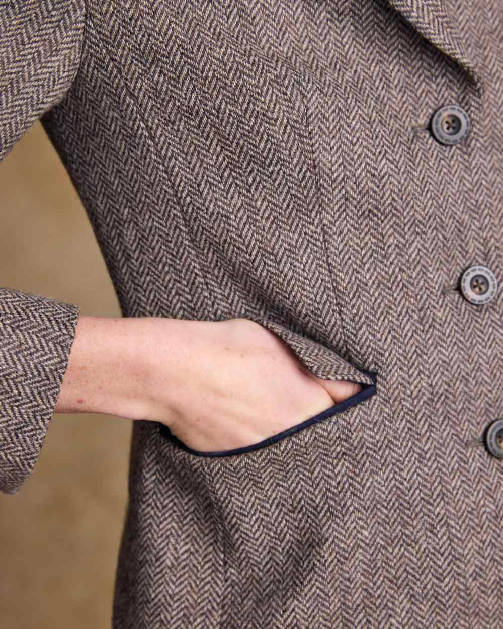 Light Tan Herringbone coloured Jack Murphy Womens Tara Tweed Hacking Jacket on textured 