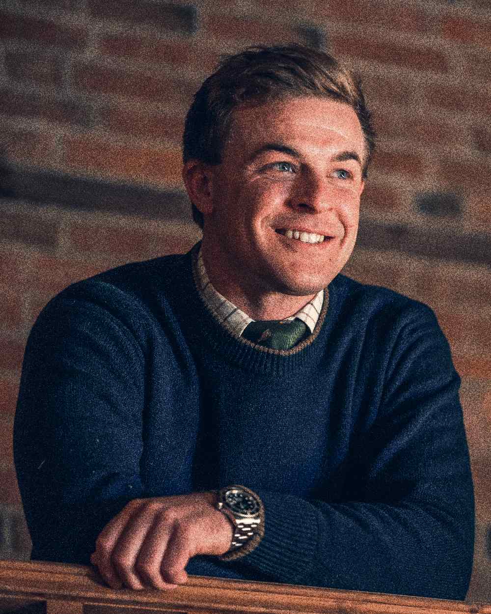 Navy coloured Jack Pyke Ashcombe Lambswool Crewknit Pullover on brick wall background 