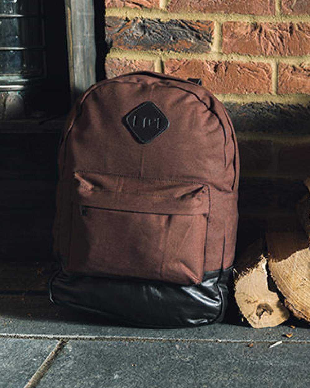 Brown coloured Jack Pyke Canvas Back Pack on brick wall background 