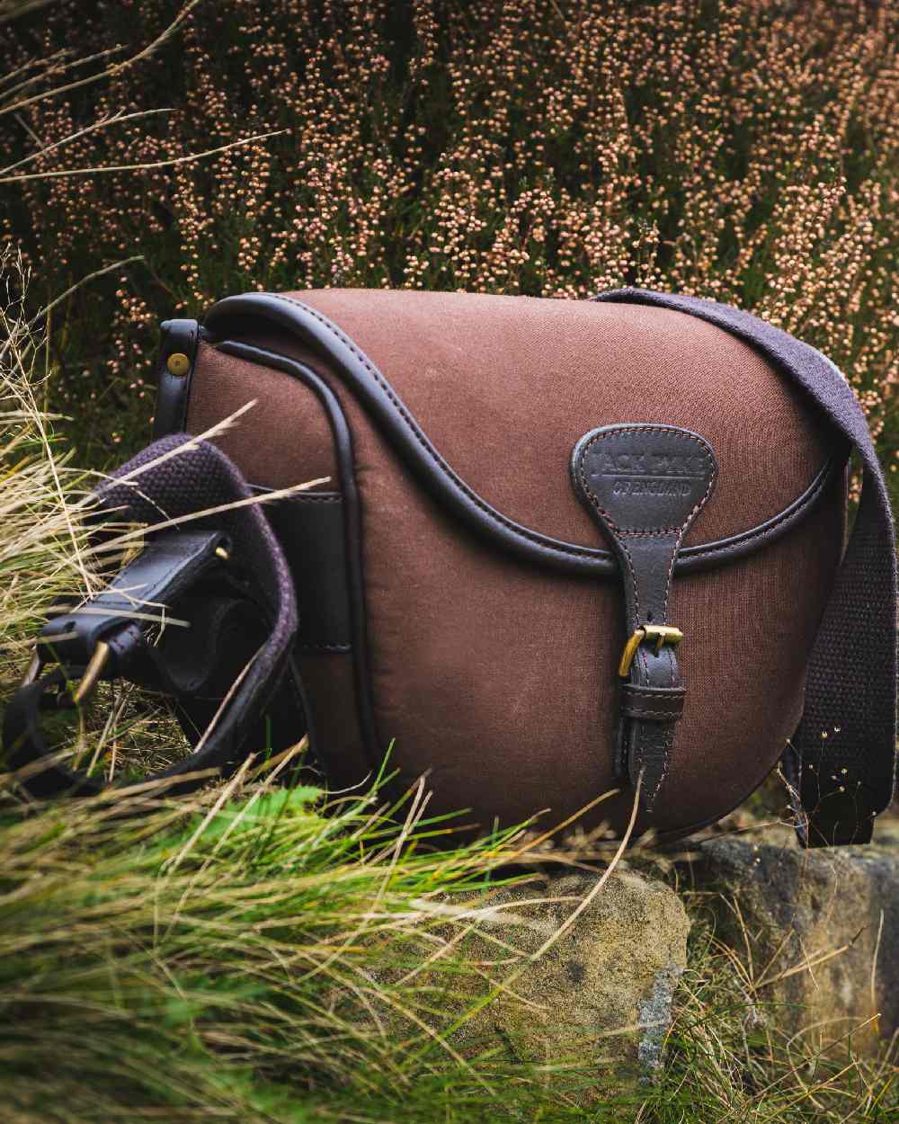 Brown coloured Jack Pyke Canvas Cartridge Bag on grassy background 