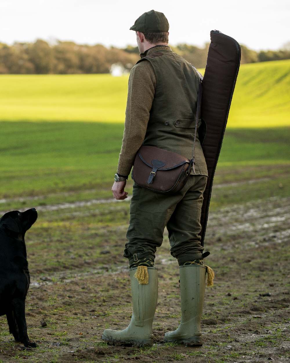 Brown coloured Jack Pyke Canvas Cartridge Bag on grassy background 